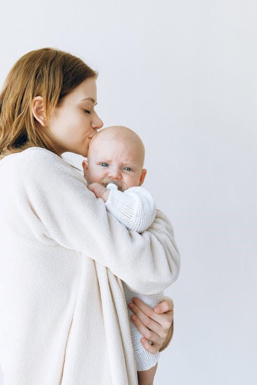 Mother carrying baby