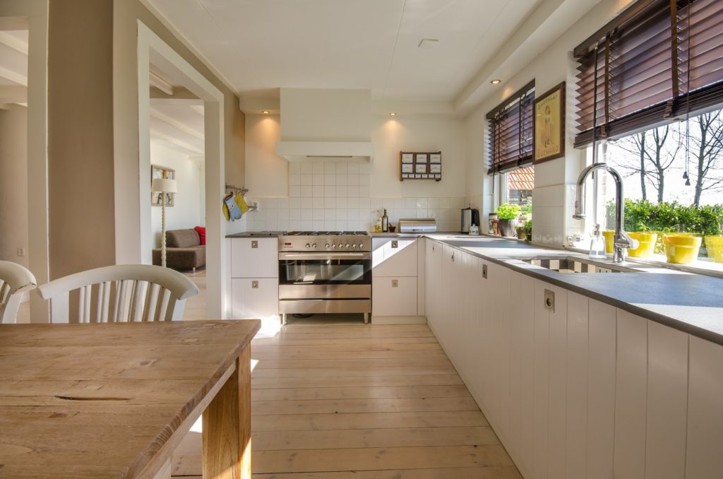 an open kitchen with wooden flooring