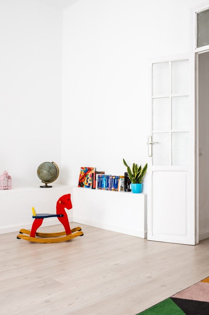 a kid’s playroom with rocking horse