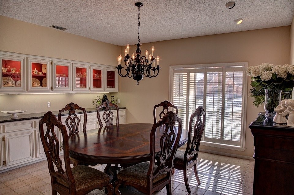 Wooden dining table in the kitchen with wooden furniture.