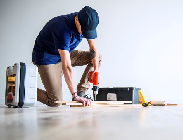 a flooring contractor installing a hardwood floor
