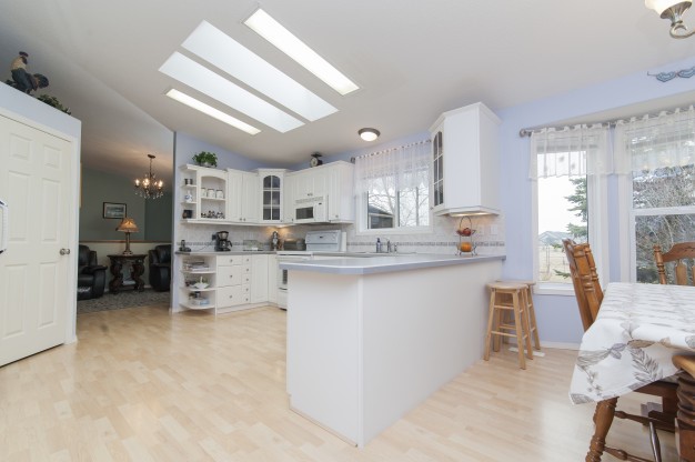 A kitchen counter and dining area with a hardwood floor