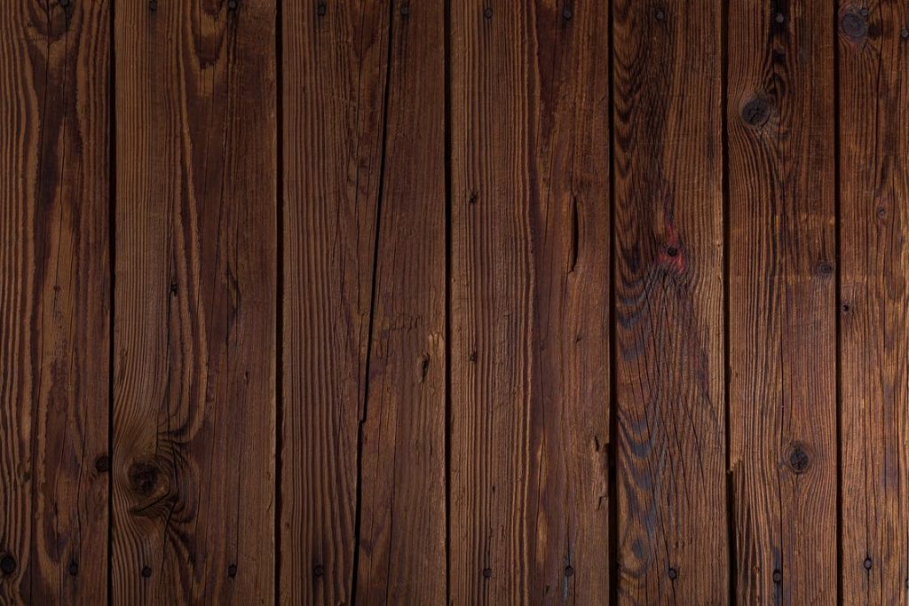Hardwood flooring in dark, scratched wood.
