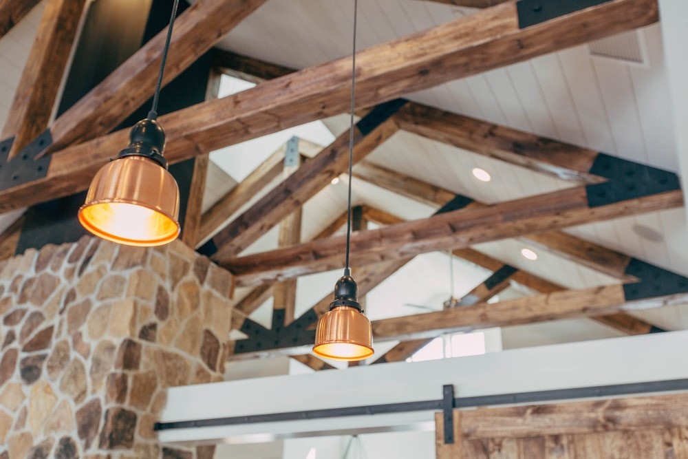 A house with decorative ceiling beams and pendant lights.