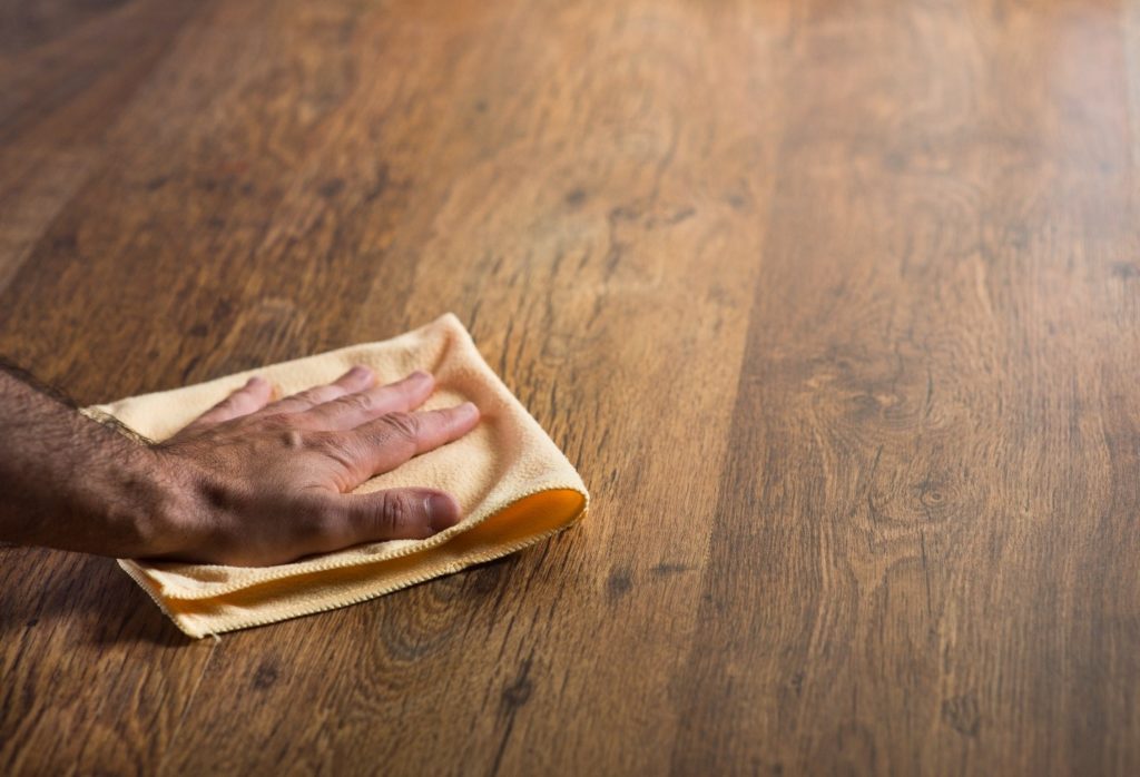 A person wiping a hardwood floor