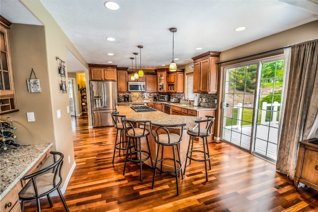 A kitchen with newly installed hardwood floors.