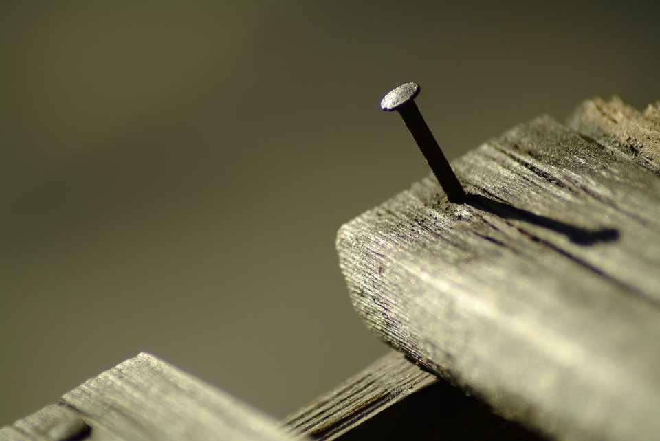 Nail Sticking Out of A Piece of Wood