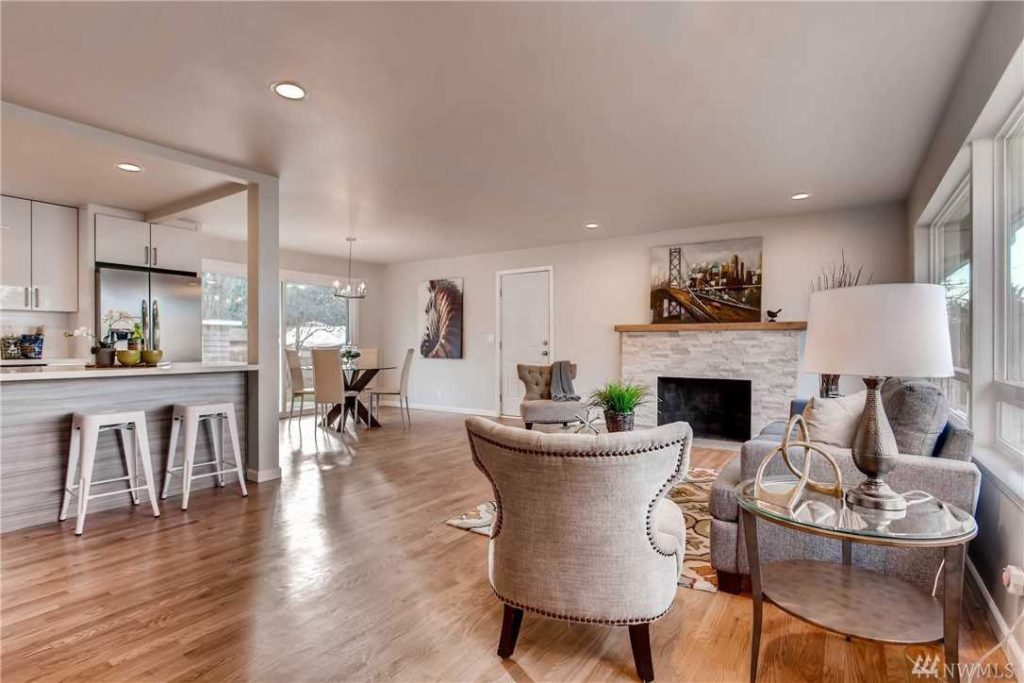 Glossy finish hardwood floors refinished in a living room by Five Star Hardwood