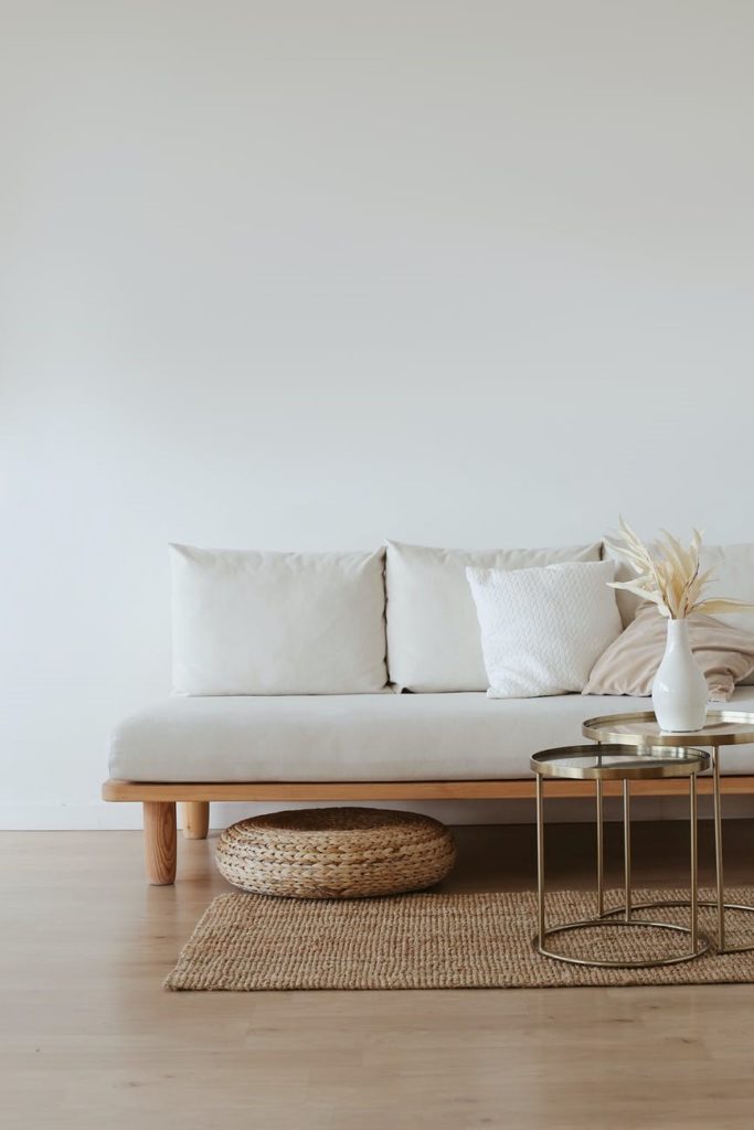white couch, rug, and table on a wooden floor