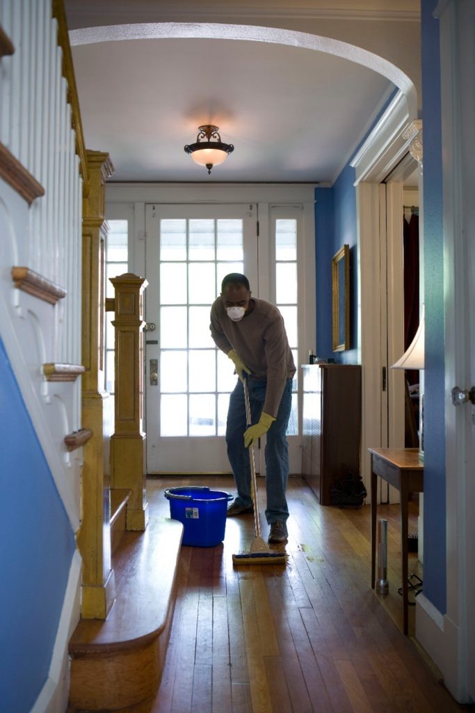 A person mopping their hardwood floor