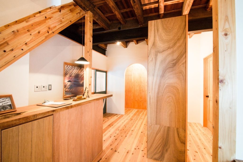 An illuminated basement interior with hardwood flooring