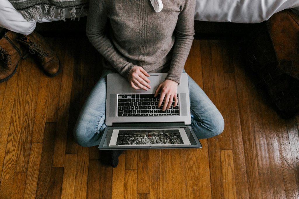 Woman sitting on a hardwood floor