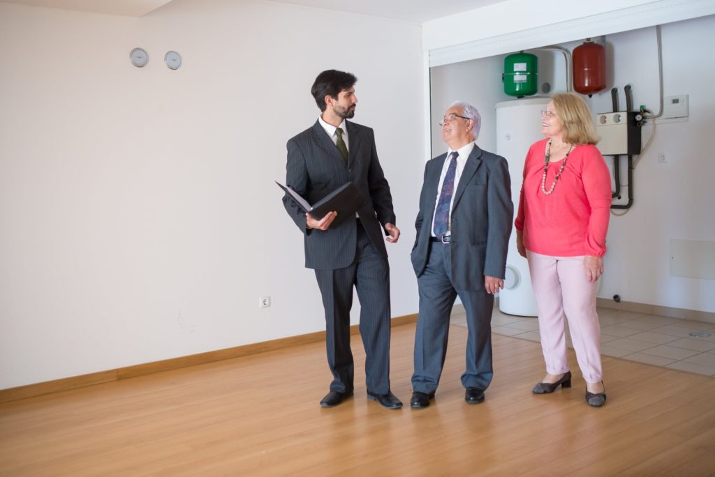 Elderly couple talking to a realtor