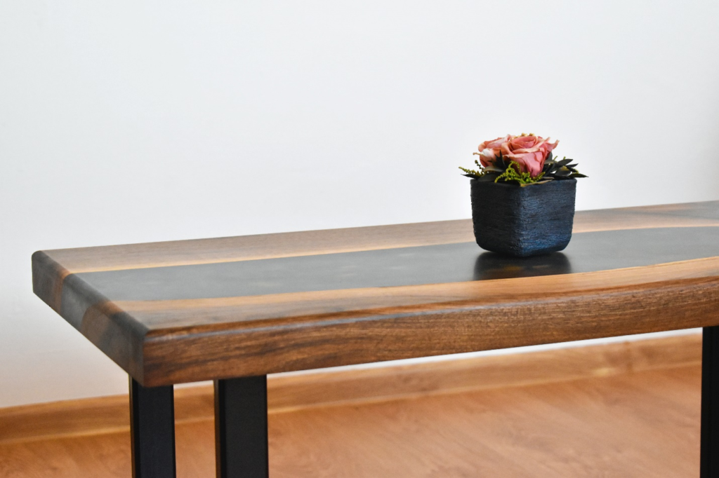 A table with a flower pot.