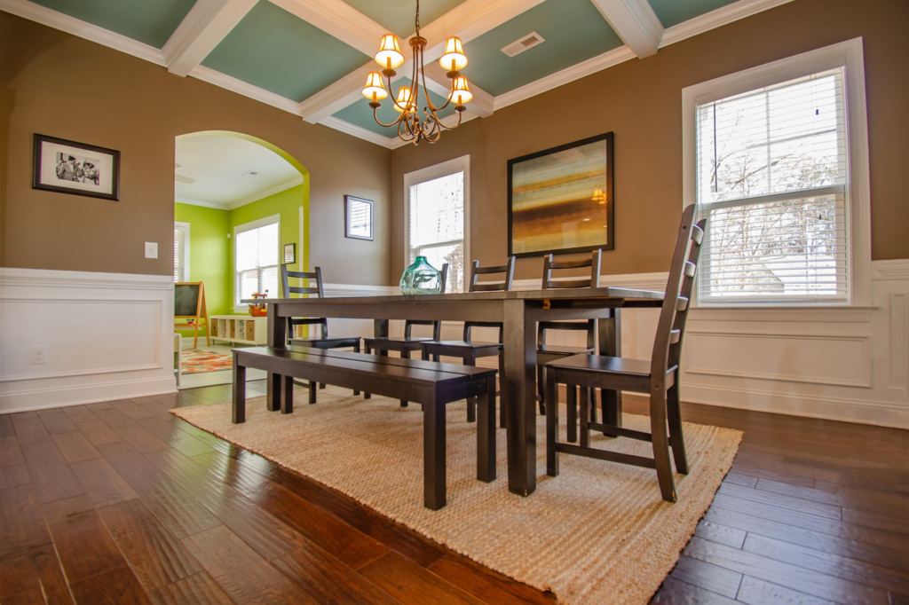 a dining table and chairs on a wood floor