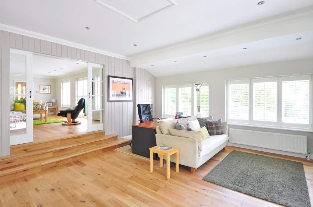 a wood-floored living room with a white couch