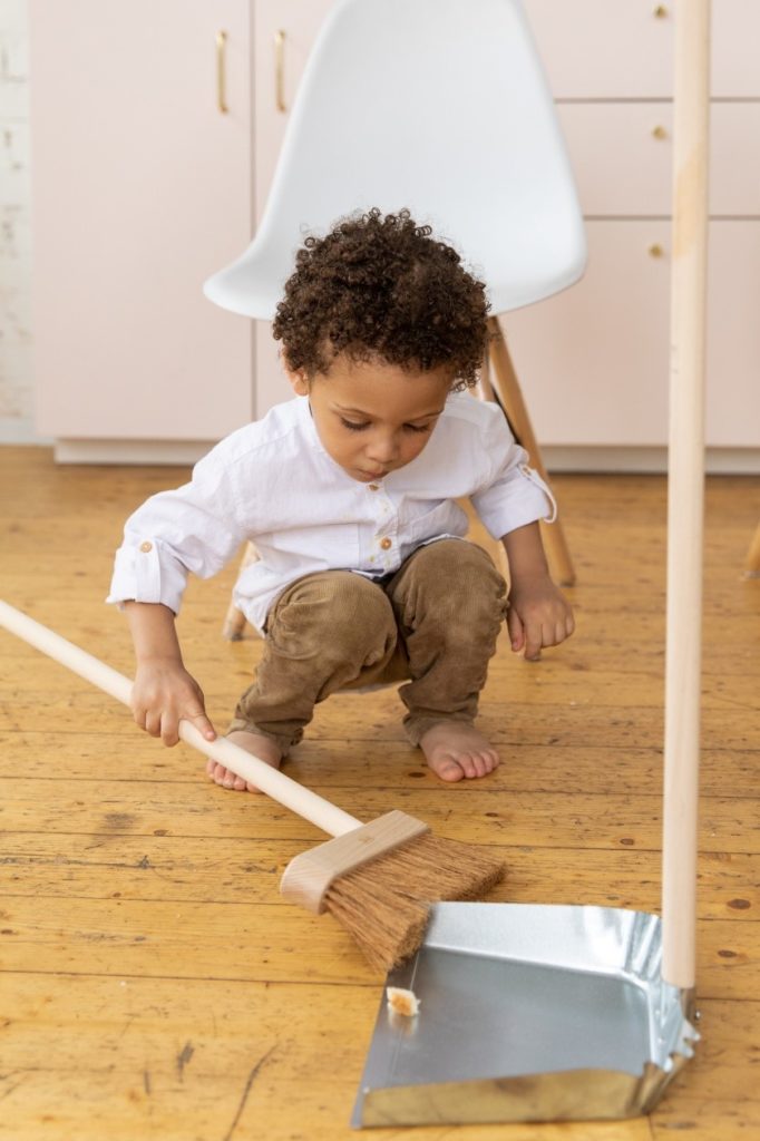 A child holding a sweeper