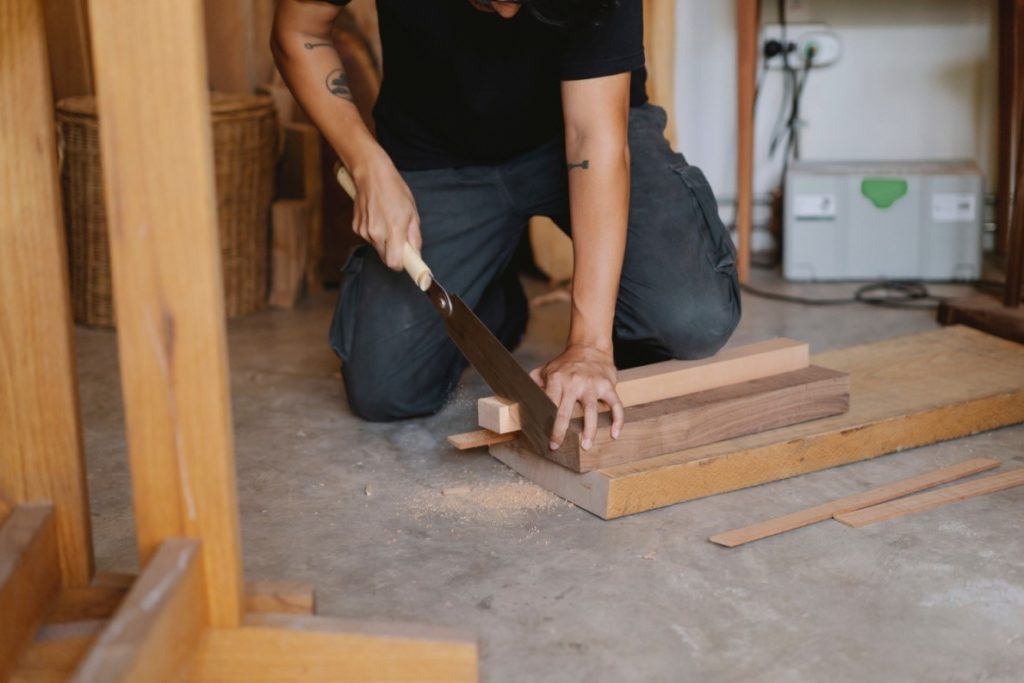 Man cutting wood for installation