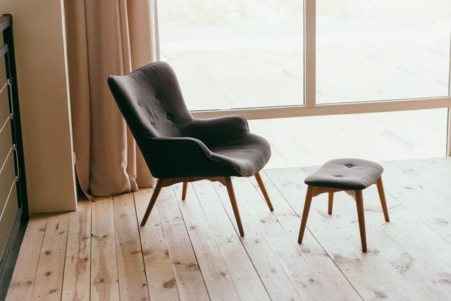 A chair and stool on wood floor