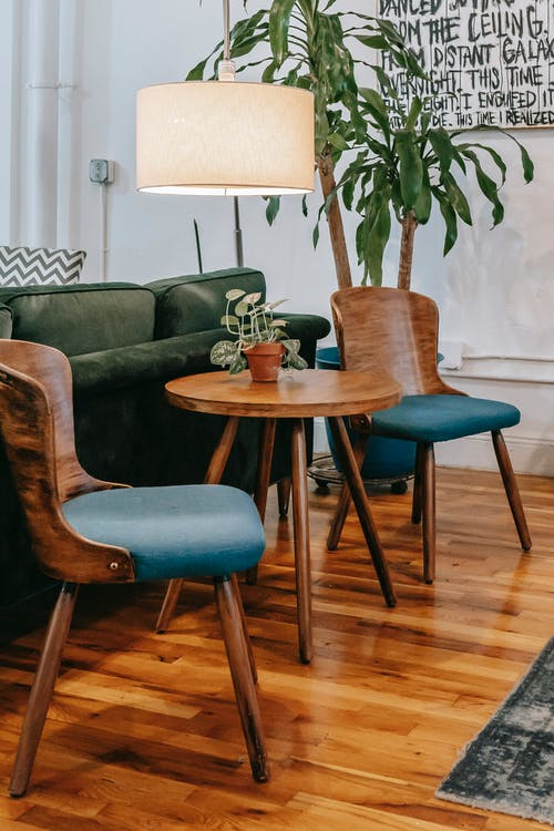 2 chairs with a center table on a hardwood floor
