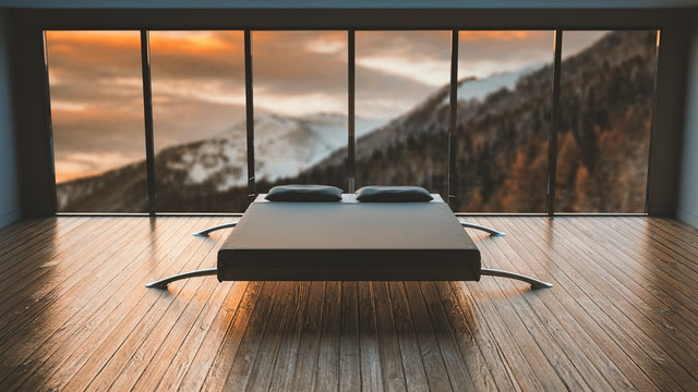 Bed in front of a large window