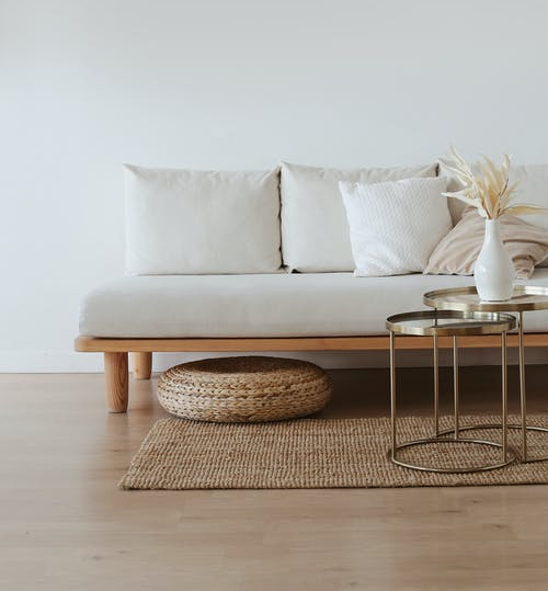 Sofa, table, and rug on a smooth hardwood floor