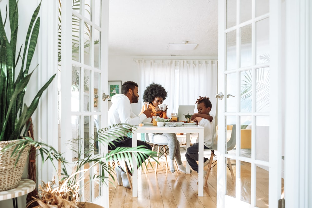 A family dining over a polished hardwood floor.