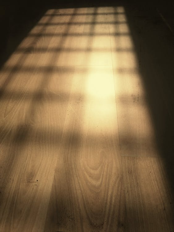 A shadow cast over hardwood floor