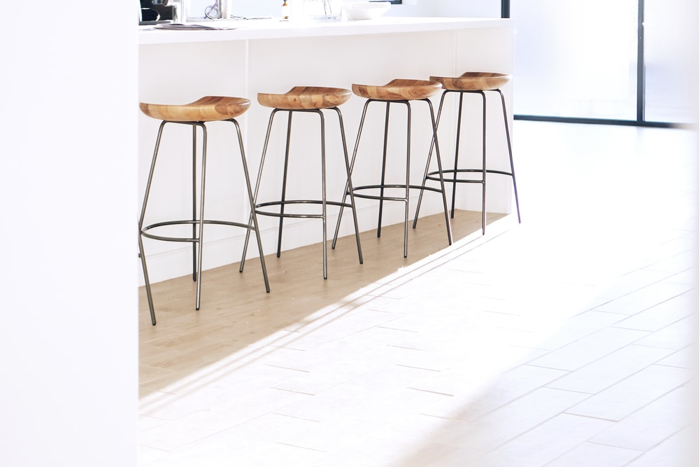 Several stools standing on white flooring