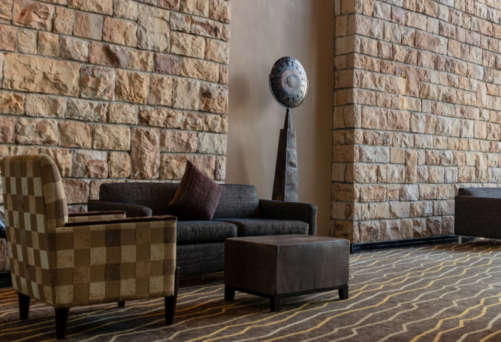 A sitting area with a brown, patterned carpeted floor