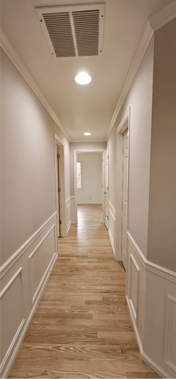 A corridor of a house with prefinished wood floor