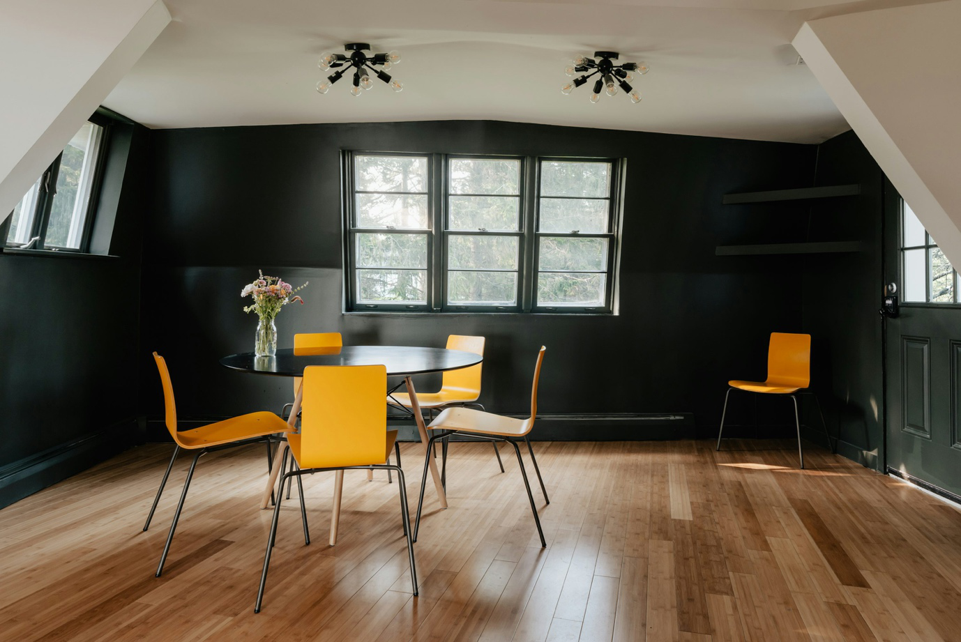 chairs and table in a black room