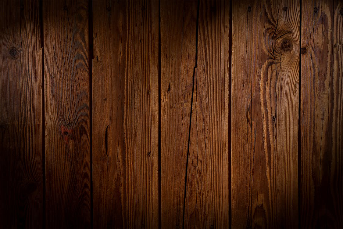 Close-up view of natural wood grains on a wooden plank, showcasing intricate patterns and textures.