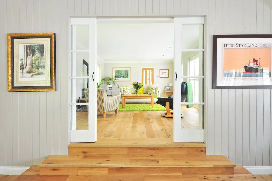 A well-furnished living room with premium hardwood flooring, enhancing the space's overall aesthetic.