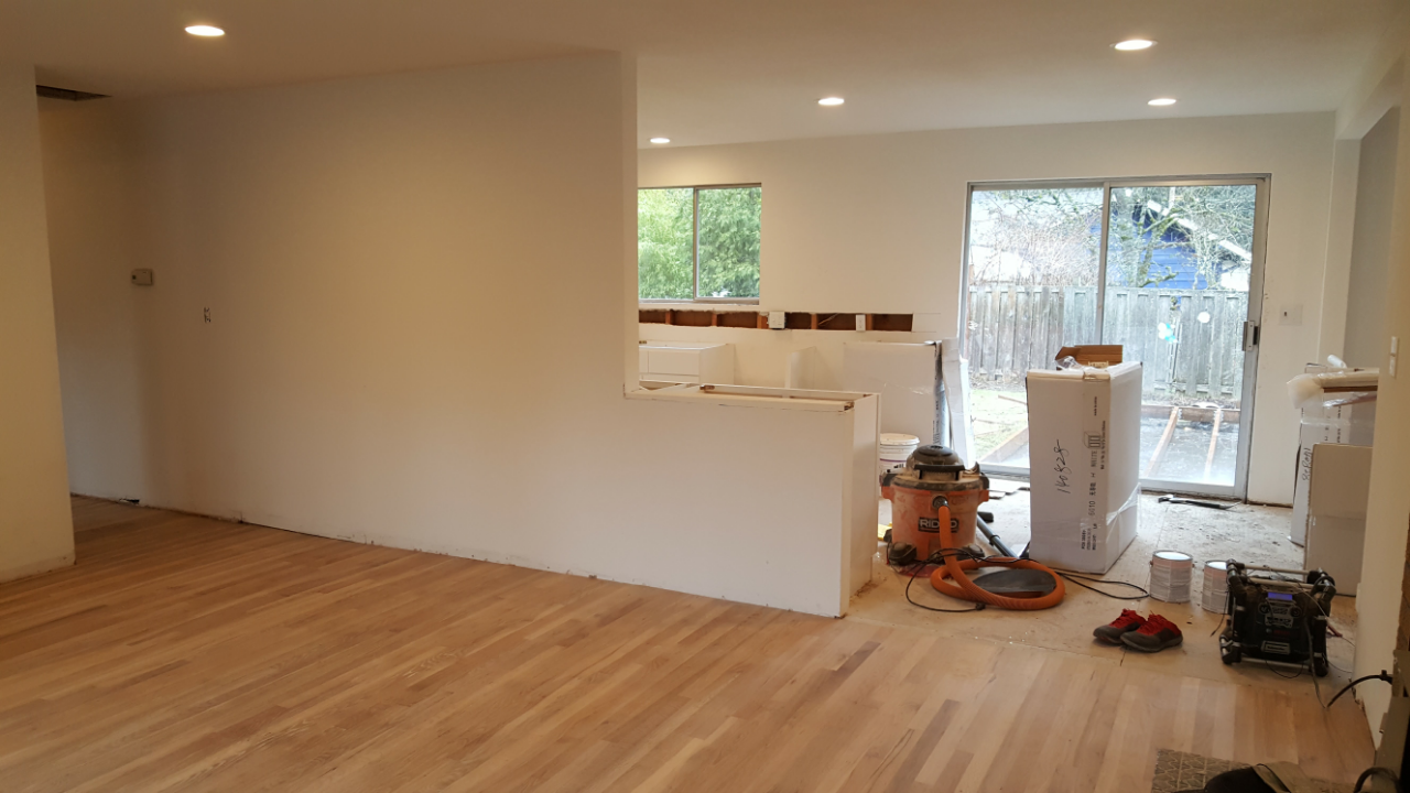Kitchen with wood floor discoloration, showing the signs of damage and wear from cheap flooring.