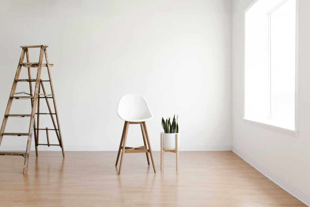 A white chair on a wooden floor