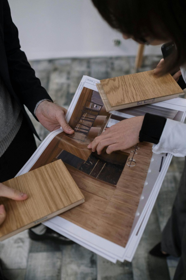 Two people discussing wood samples and designs
