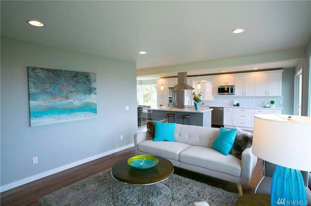 A before picture of a living room with dark wooden floors