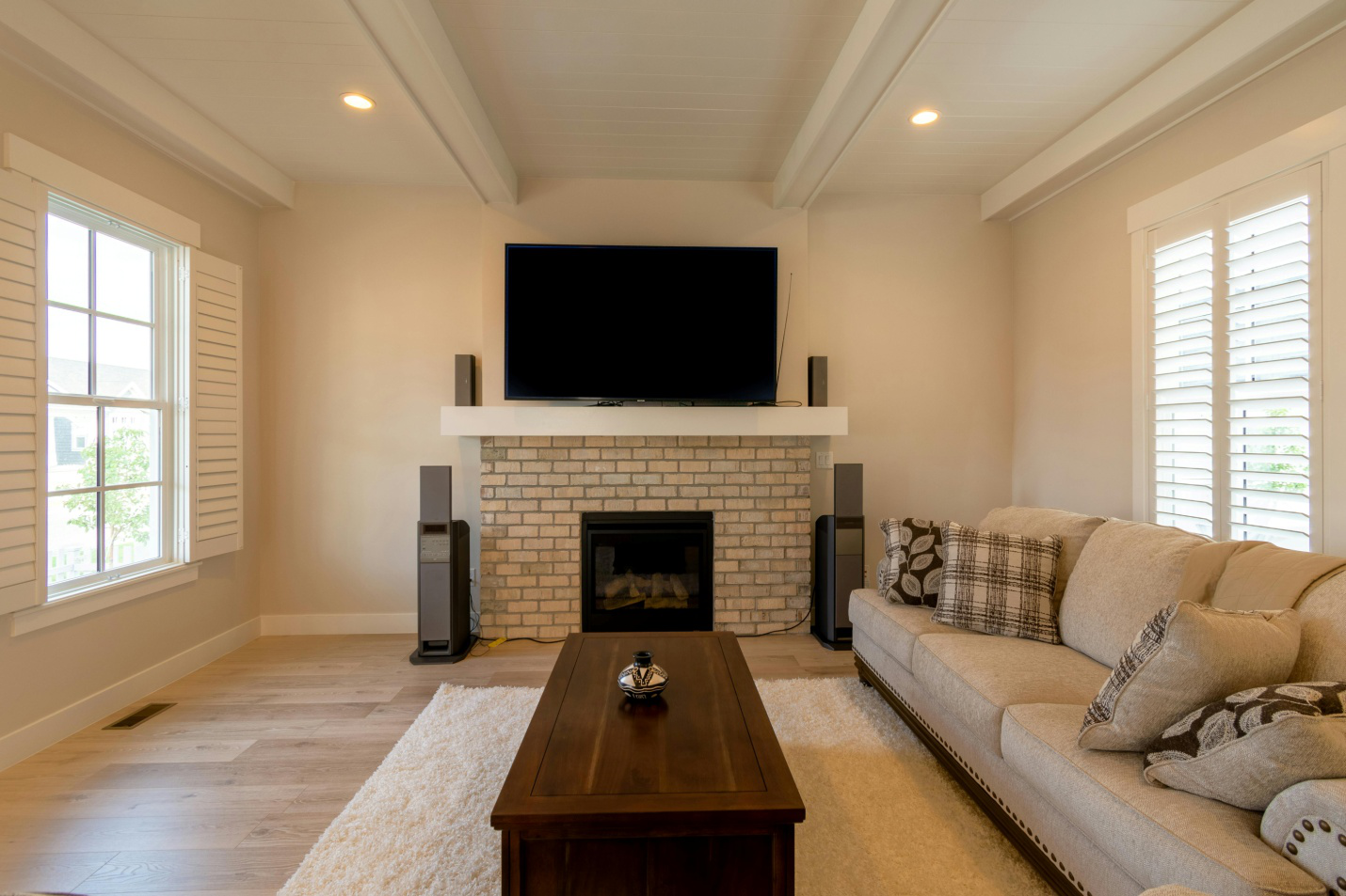 ligh toned hardwood flooring  in a room with 2 windows